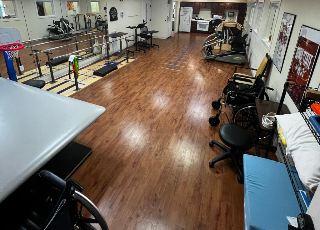 Rehabilitation area with exercise equipment and wooden floor