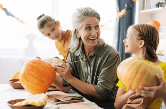 Residents enjoying pumpkin carving during a group activity.