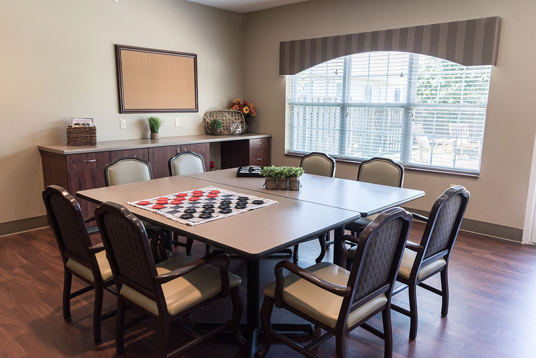 Bright common area with a table and chairs
