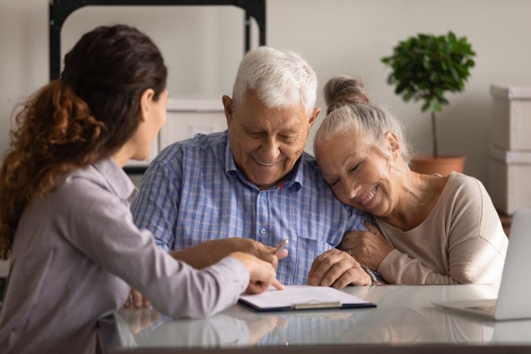 Residents and staff enjoying a friendly conversation indoors
