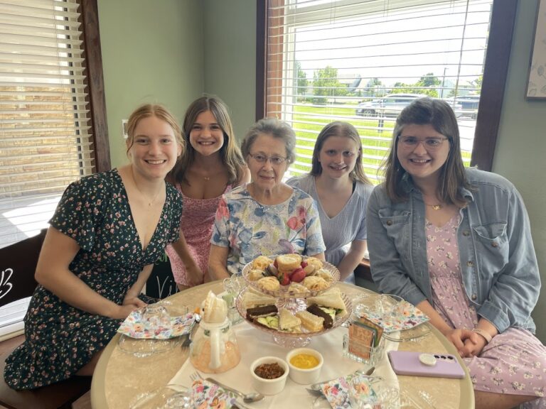 Residents and staff enjoying pastries in a dining area