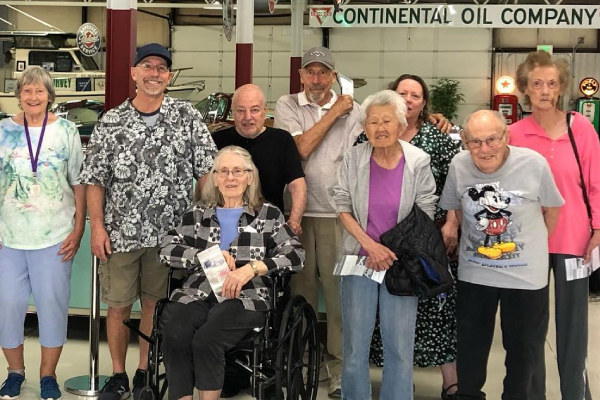 Group of residents and staff smiling together indoors