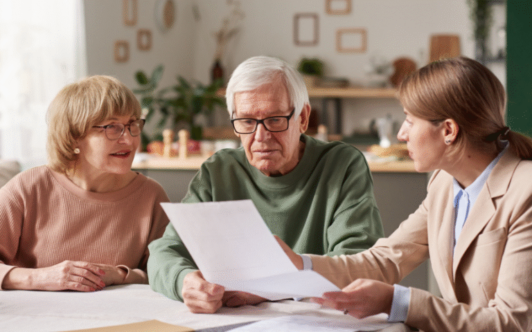 Residents and staff engaged in a discussion over documents