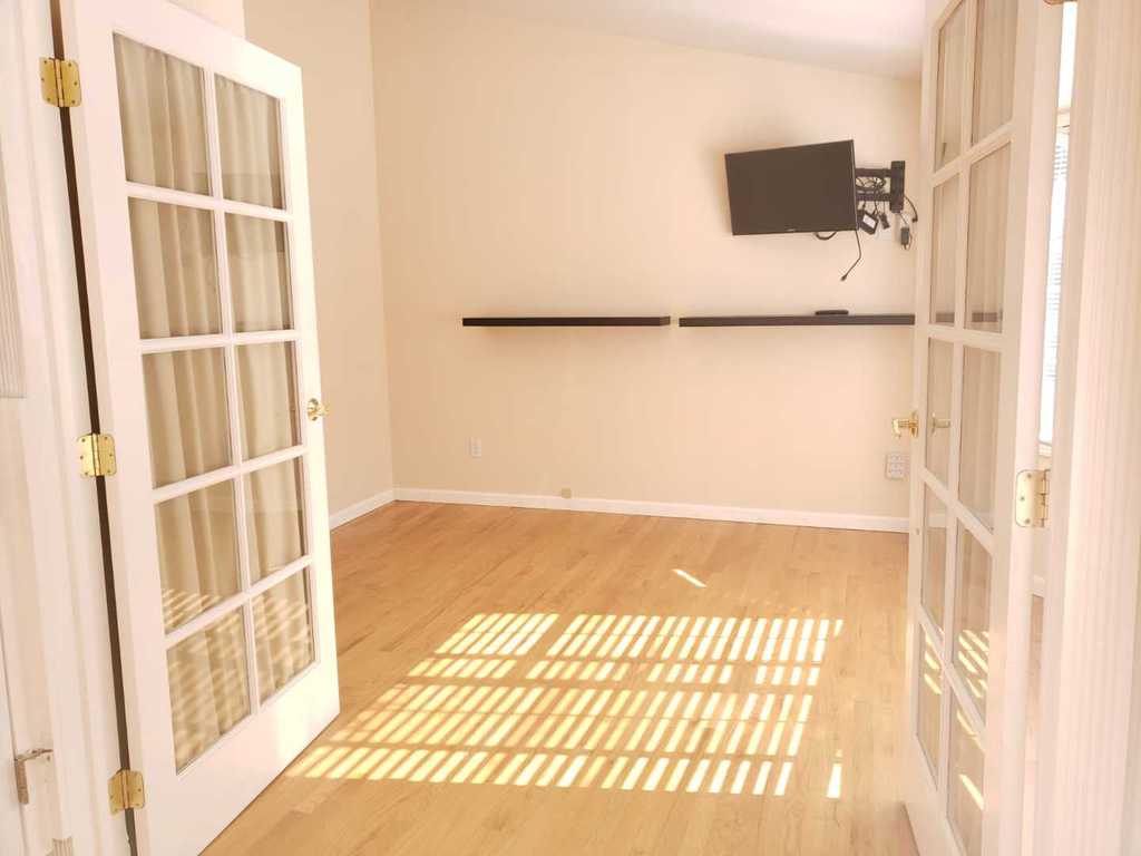 Bright and spacious interior room with wooden flooring