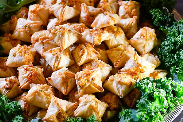 A platter of stuffed pastry bites arranged on a tray