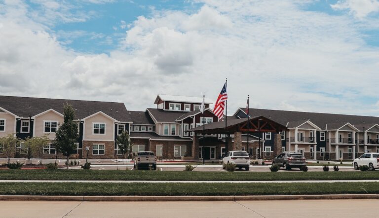 Building exterior of Northridge Village with flags