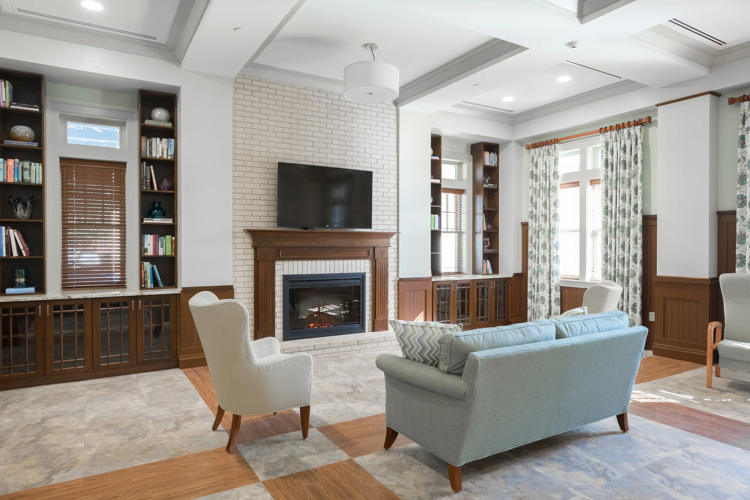 Well-lit common area with a fireplace and comfortable seating