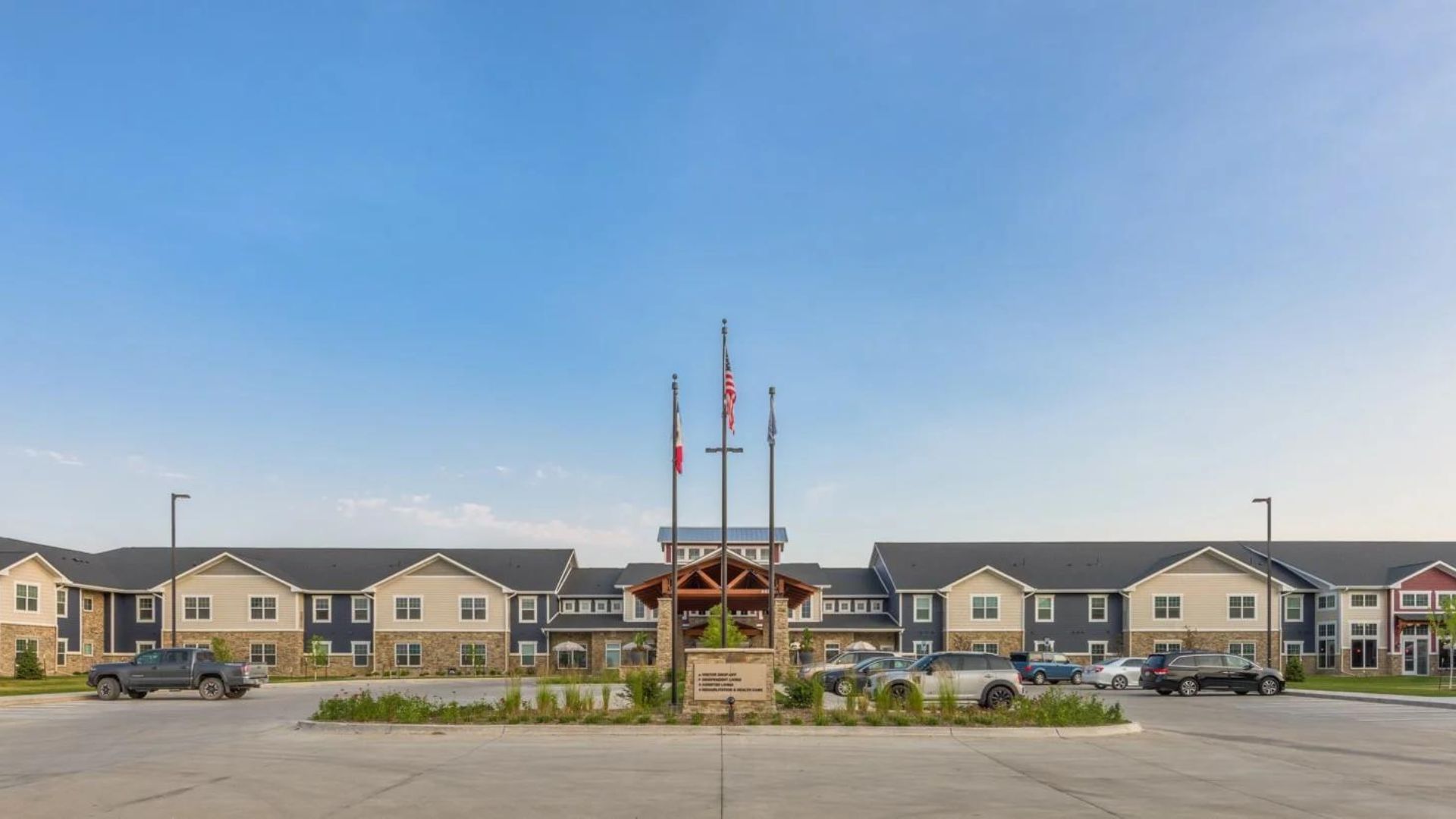 Front view of Northridge Village with flags and landscaped area