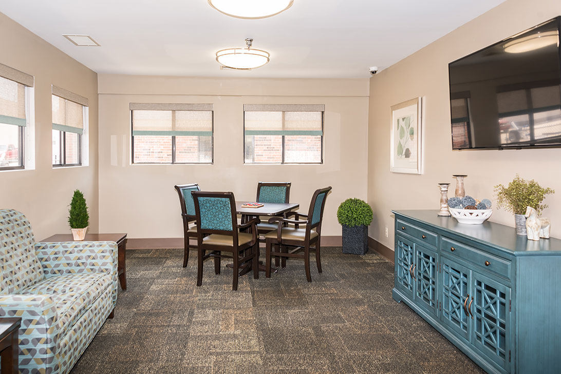 Bright common area with seating and dining table
