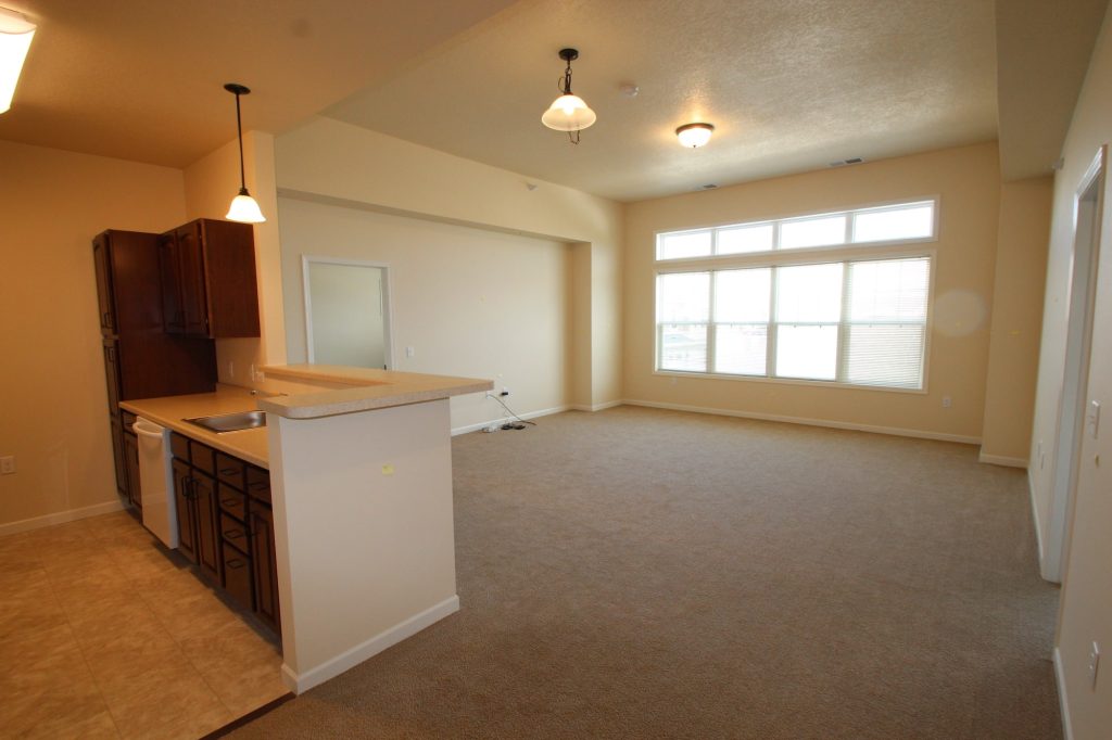 Bright and spacious living area in a senior facility unit