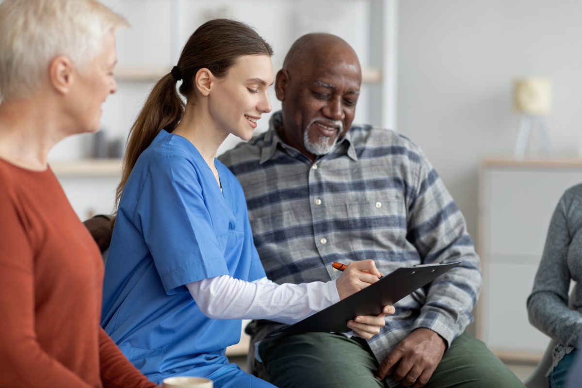 A staff member engaging with residents in a common area
