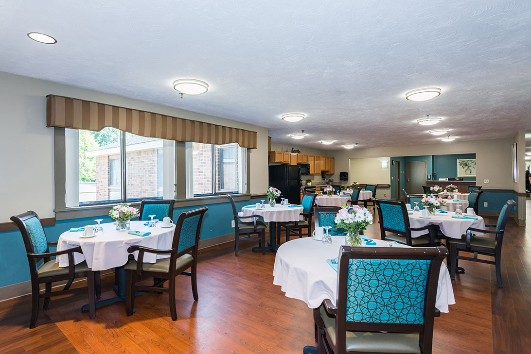Bright dining room with tables set for meals