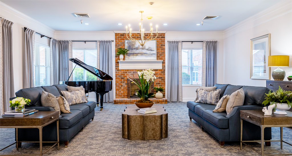 Bright and inviting common area with piano and seating