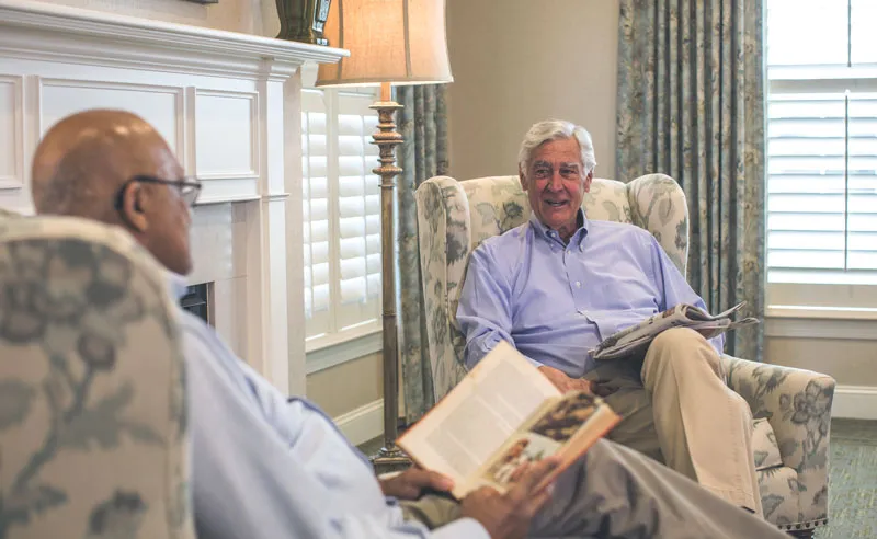 Two residents enjoying a conversation in a common area