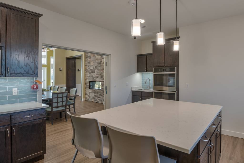 Modern kitchen area with seating and appliances