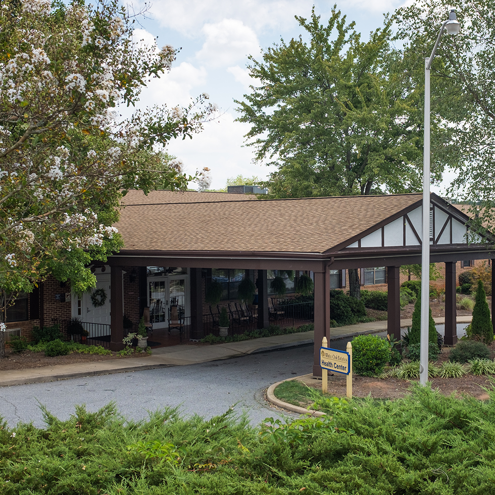 Building entrance of White Oak Manor Charlotte with landscaping