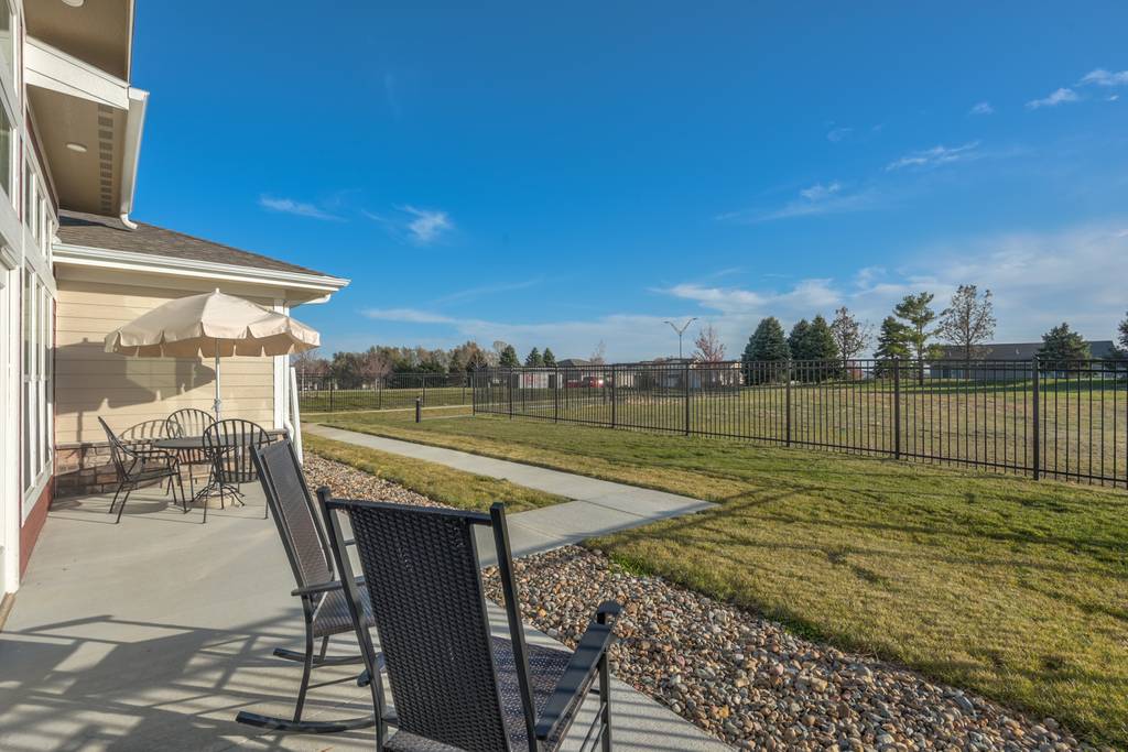 Outdoor patio area with chairs and a view
