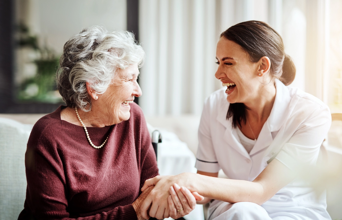 Caregiver and resident laughing together