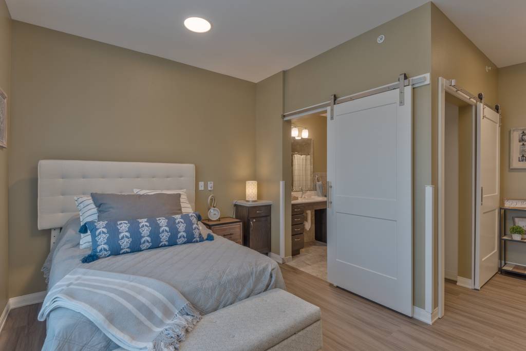 Cozy resident room with bed and bath entrance