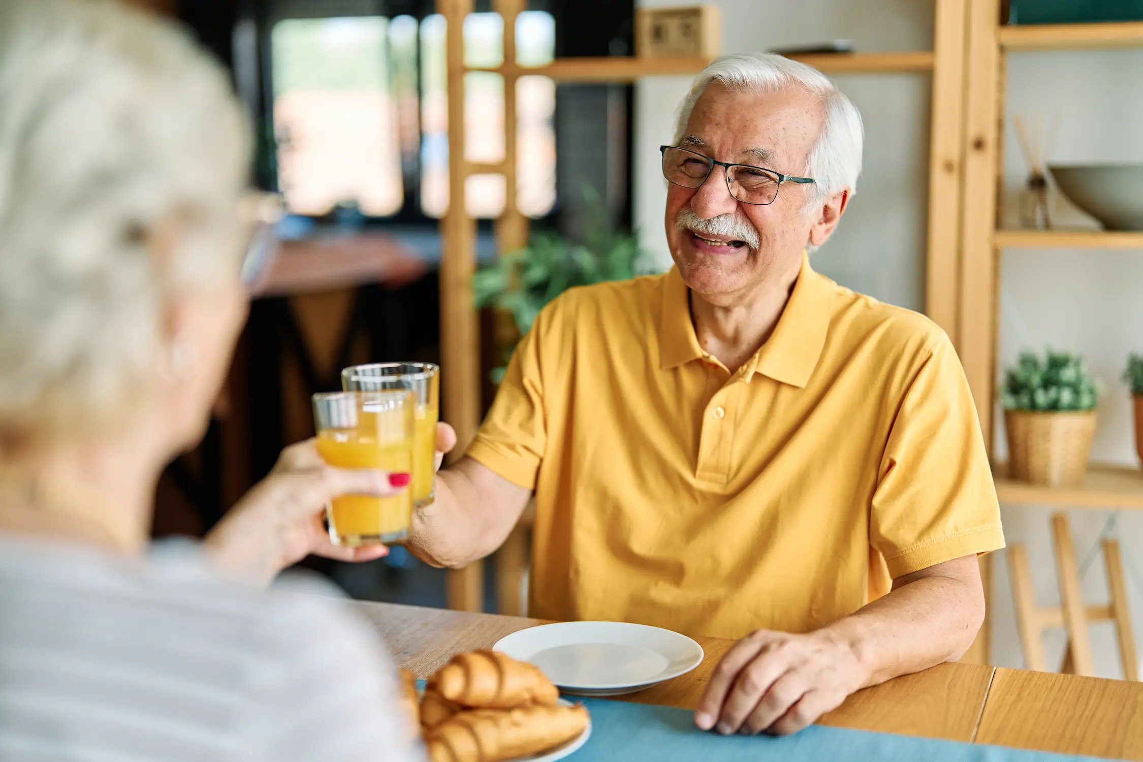 Senior man enjoying a drink with a woman