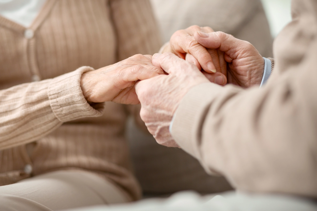 Two hands holding each other in a caring gesture