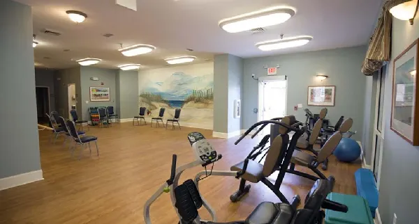 Interior fitness area with exercise equipment and chairs