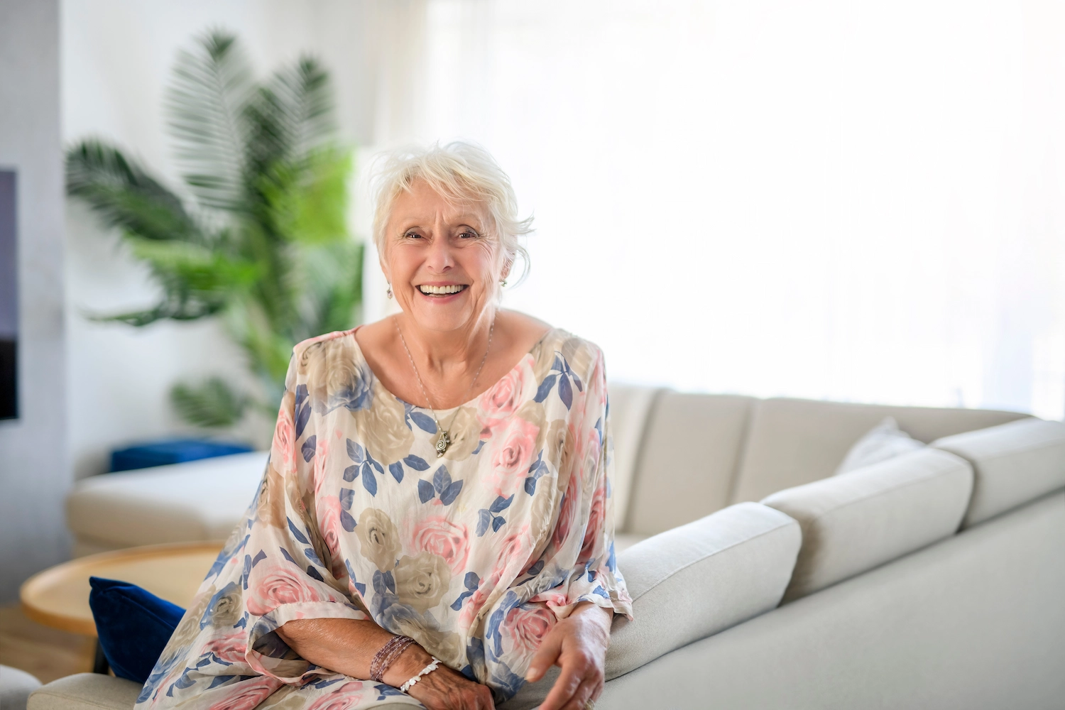 Resident smiling in a bright interior space