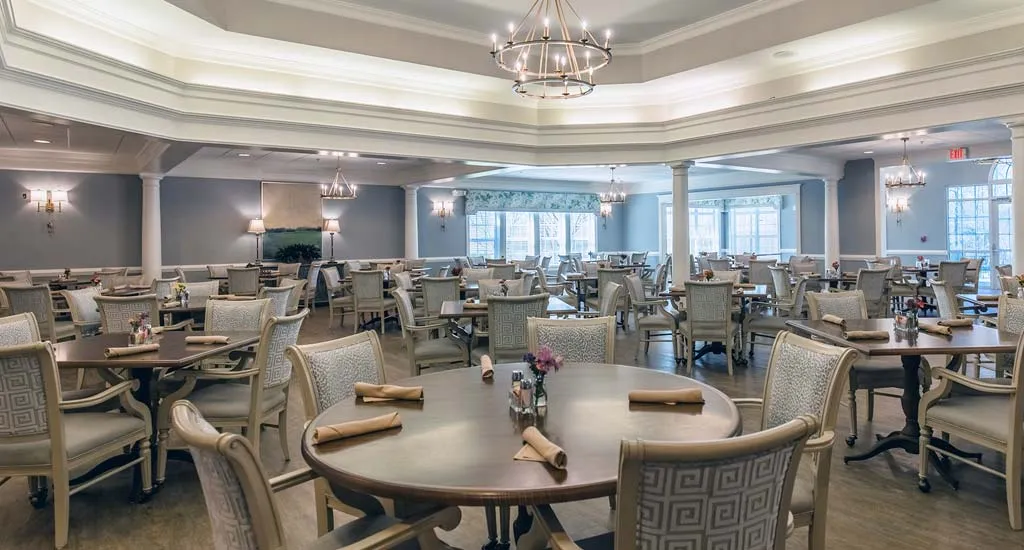 Dining room with multiple tables and elegant decor