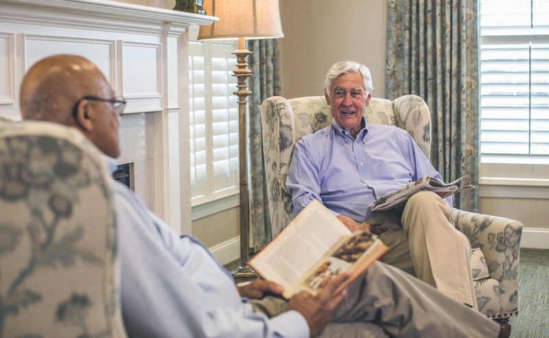 Two residents enjoying conversation in a common area