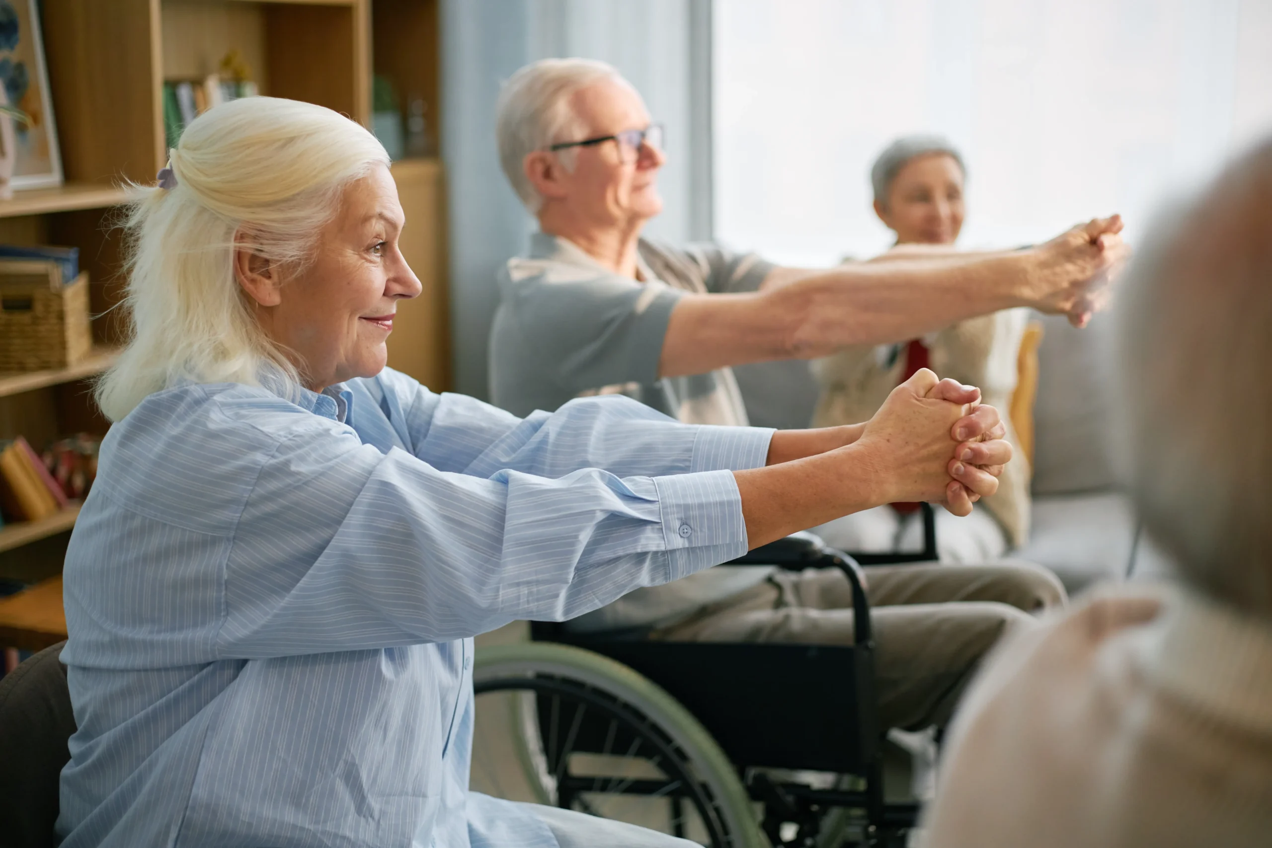 Residents participating in a seated exercise class