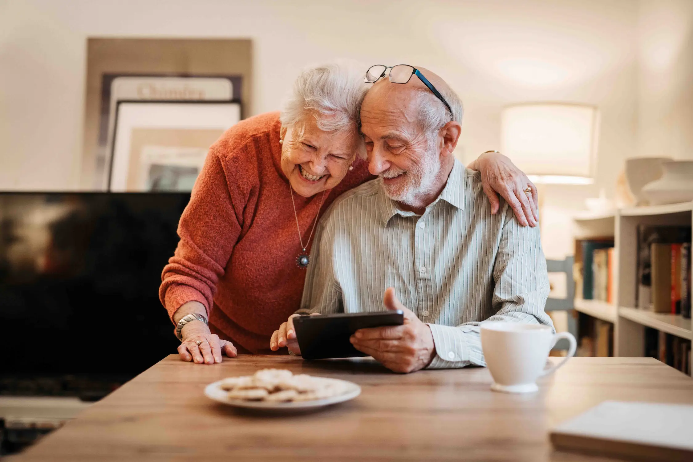 Senior couple enjoying time together while using a tablet