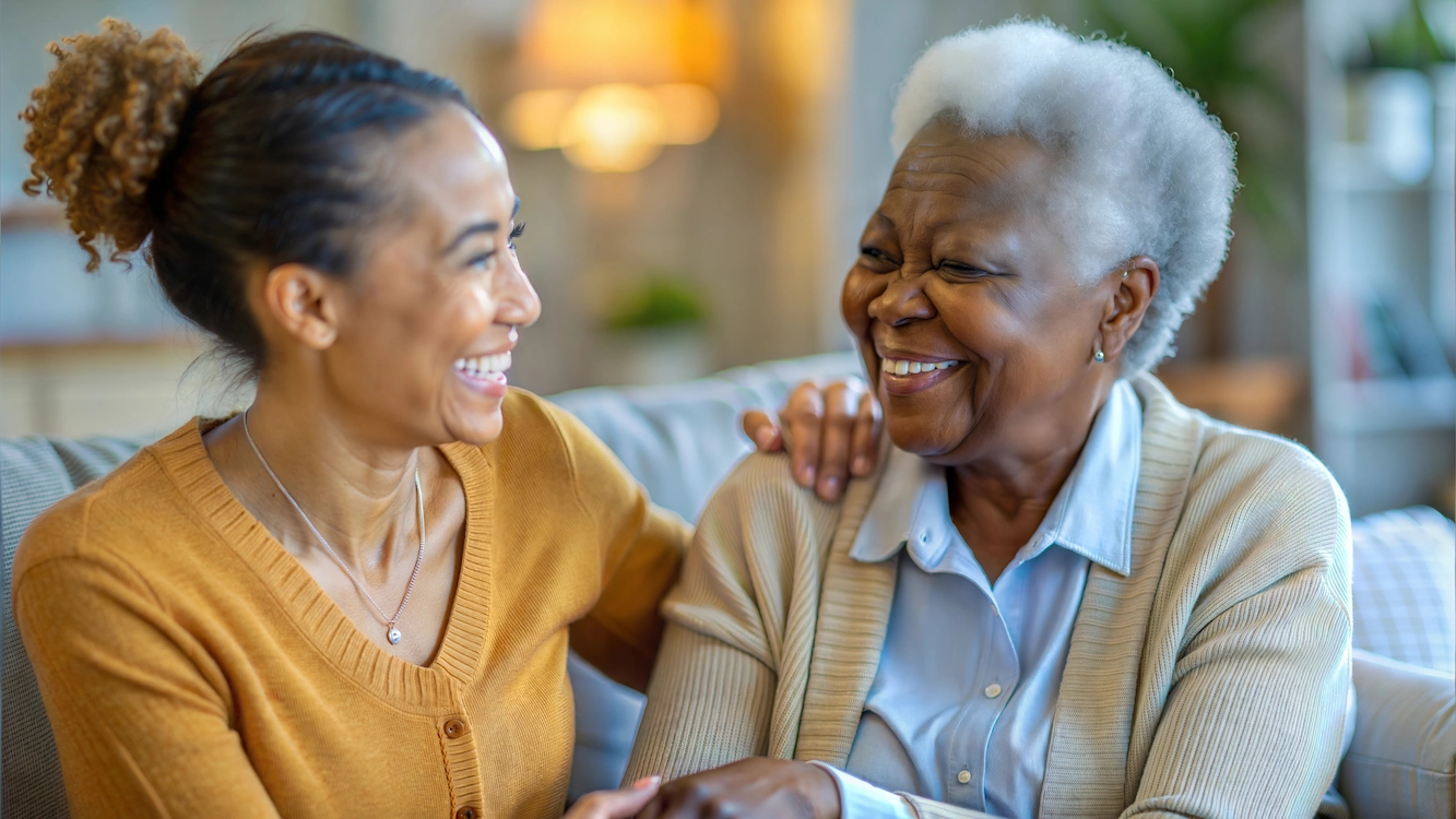 Two women smiling and enjoying a conversation
