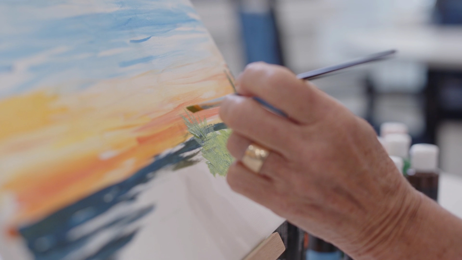 Close-up of a senior painting on canvas