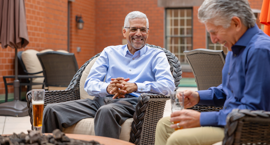 Two residents enjoying time on a patio