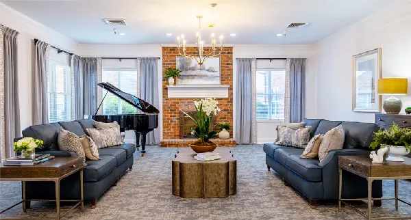 Bright common area with seating and a piano