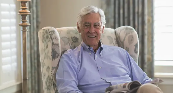 A resident sitting comfortably in a lounge chair