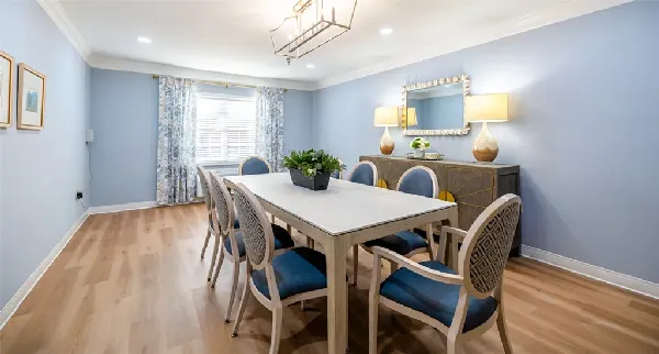 A dining room with a long table and chairs