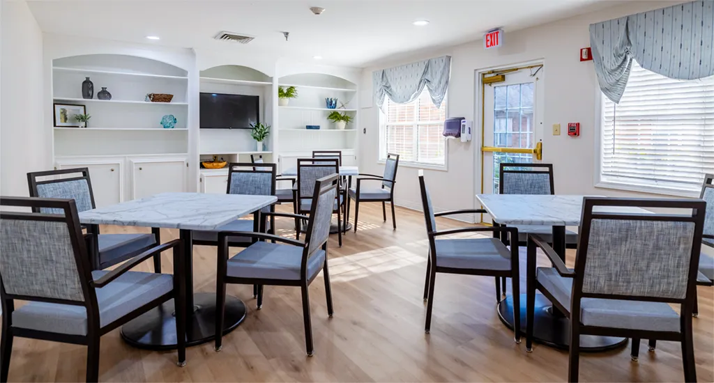 Bright common area with tables and chairs.