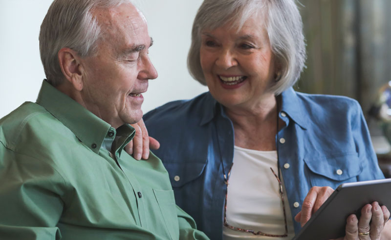 Seniors engaging in conversation with a tablet