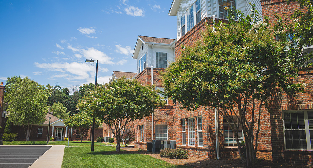Exterior view of Homestead Hills with trees and blue sky