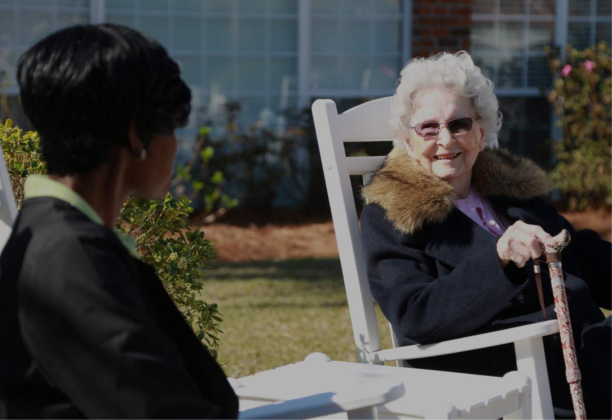 Residents enjoying outdoor seating and conversation.