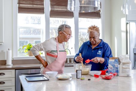 Two women baking together in a kitchen