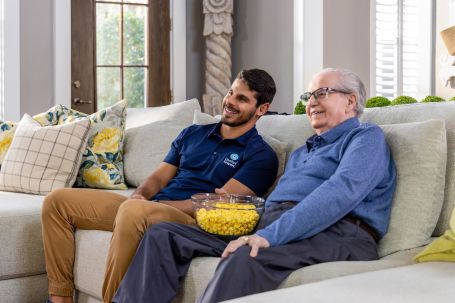 A caregiver and resident enjoying time together indoors.