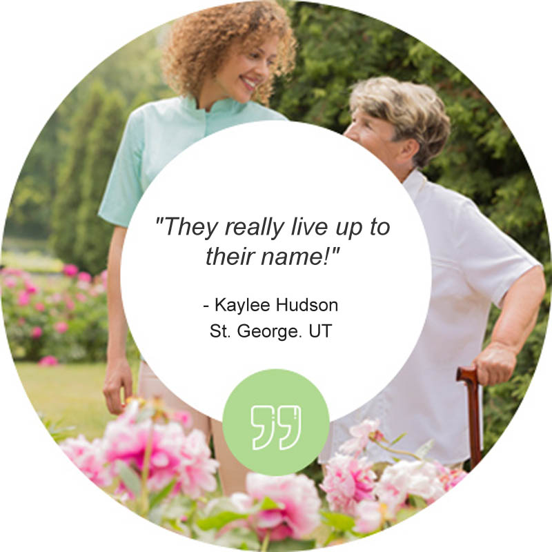 Caregiver assisting a resident in a garden.