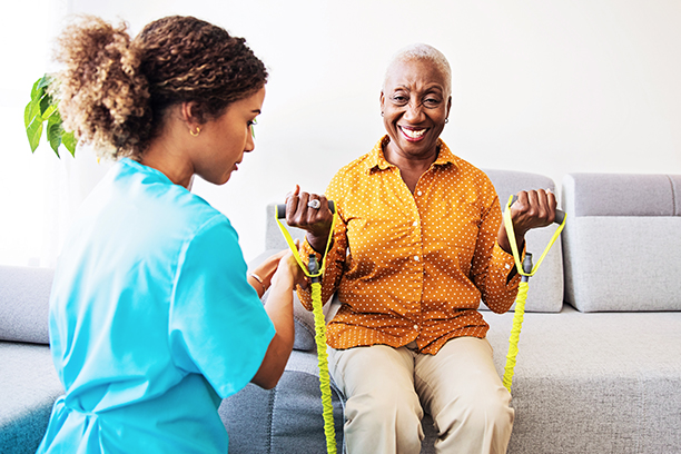 Senior woman exercising with a caregiver
