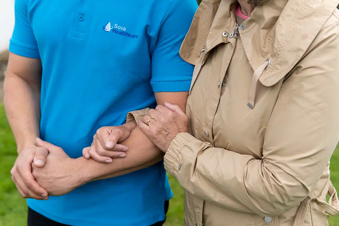 Staff assisting a resident outdoors