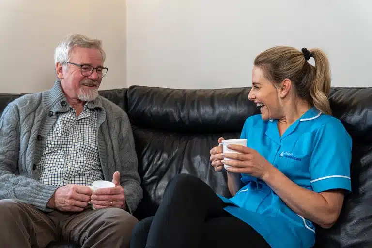 A caregiver and a resident sharing a joyful moment.