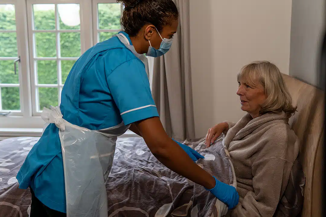 Caregiver assisting a senior resident indoors