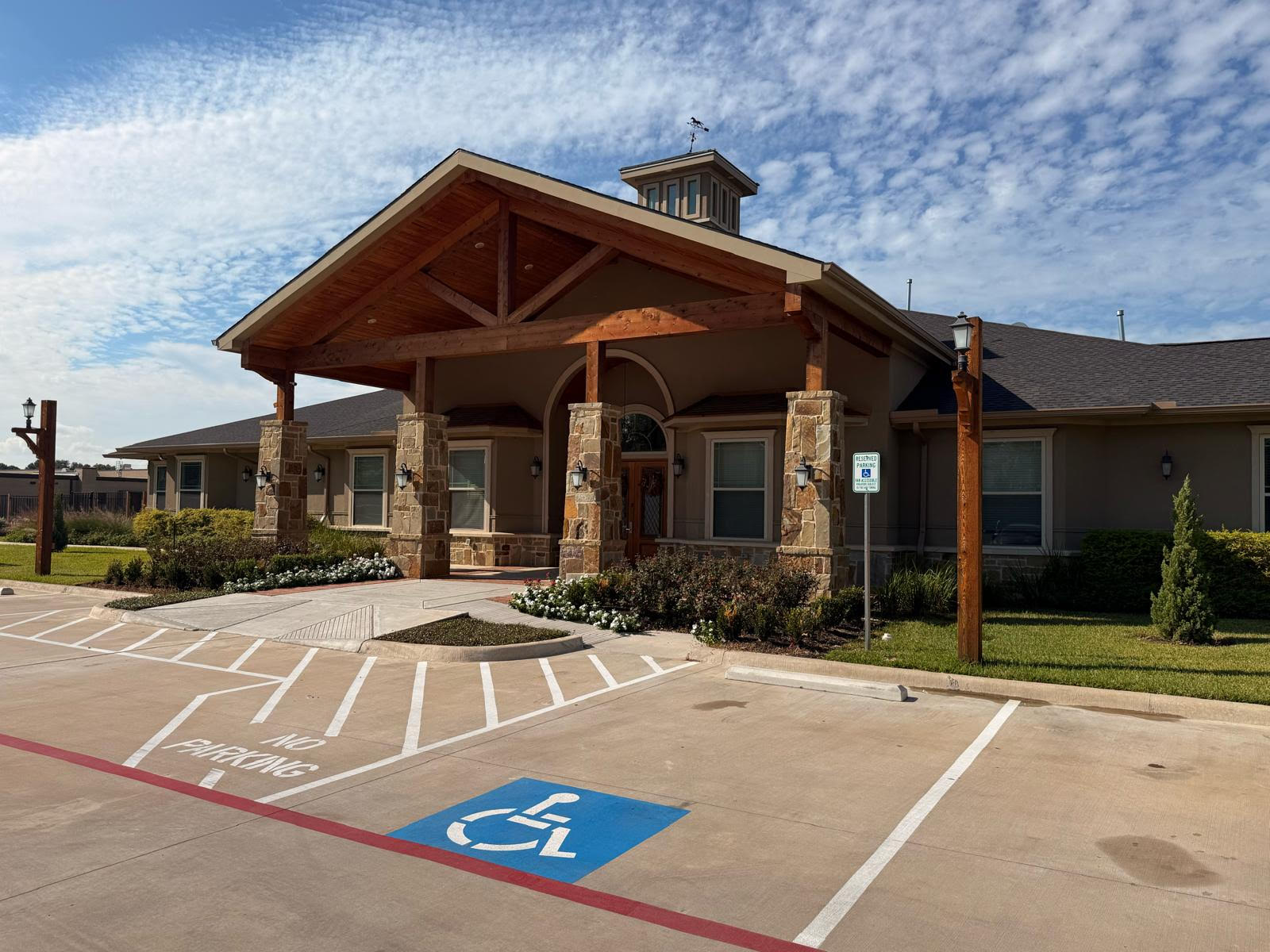 Exterior view of assisted living facility with accessible parking