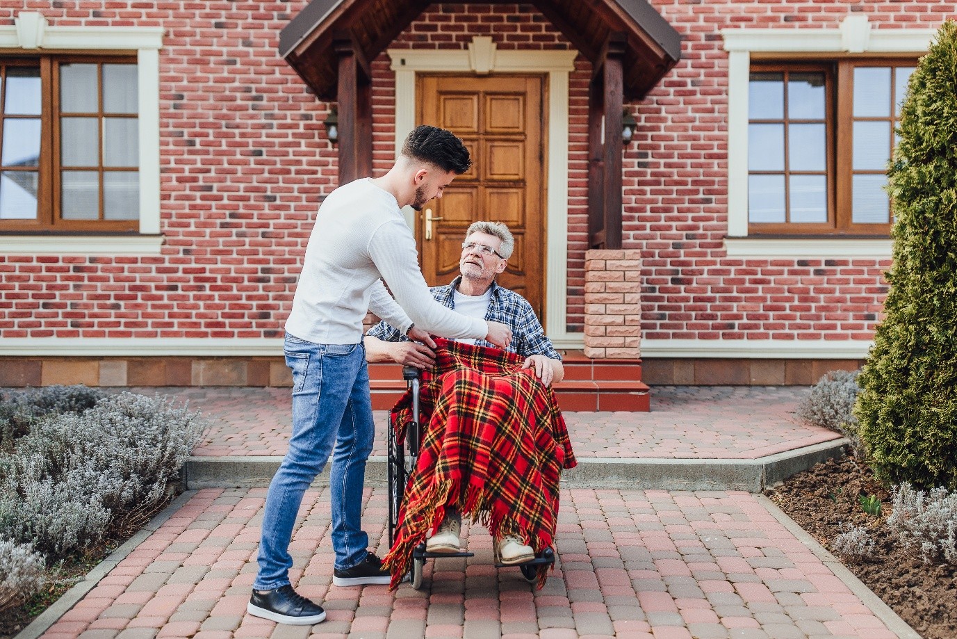 Staff assisting a resident outside a facility